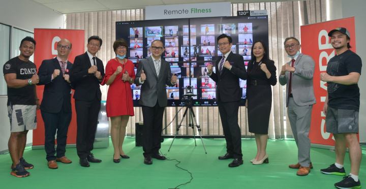 Launching Sharp's Remote Life Solutions. (sixth from left) SHARP Electronics (M) Sdn Bhd Managing Director, Ting Yang Chung, (fifth from left) Deputy Managing Director (Sales Division), Tok Sang Man, and (third from left) Assistant General Manager (Sales) and Head of Smart Solution Division, Clement Ng, trying out Remote Fitness, one of SHARP's Remote Life Solutions.