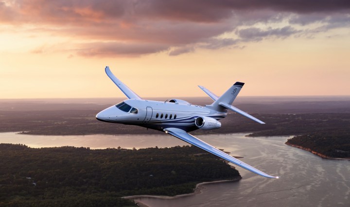 Cessna Citation Latitude flying over a river